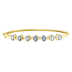 14K Yellow Gold Alternating Bezel Set 5MM Oval Shaped Tanzanite and 1/5 Cttw Diamond Bangle Bracelet (H-I Color, VS2-SI1 Clarity) - Fit's wrists up to 7.25" Inches