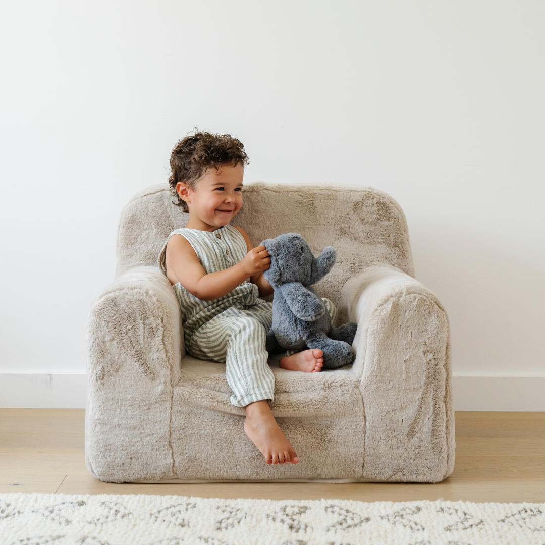 Child enjoying a plush Modern Oversized Cozy Accent Lounge Chai with a gray teddy bear.